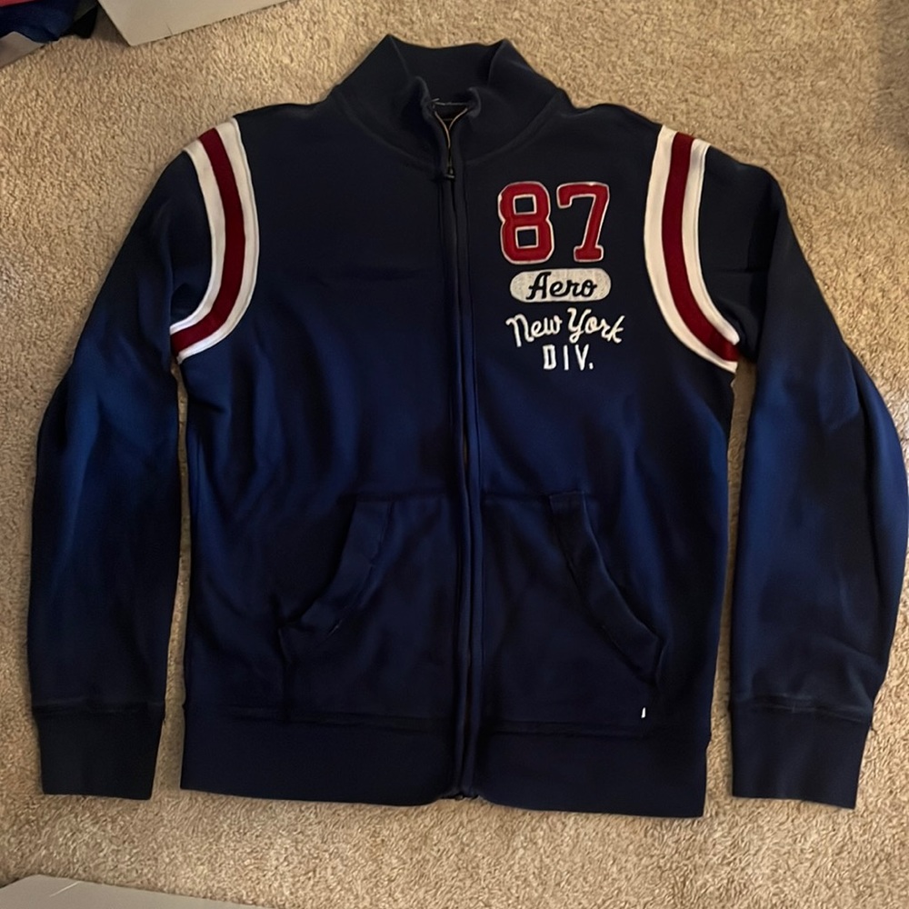 Navy zip up sweatshirt.